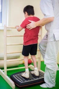 A child with Cerebral Palsy doing exercises