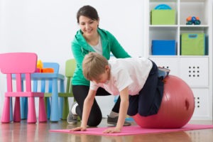 A child with Cerebral Palsy in physical therapy focusing on balance