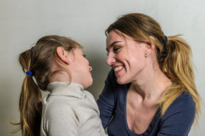 Adult and child laughing together