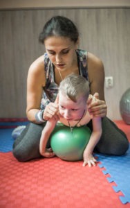 A child with cerebral palsy doing yoga