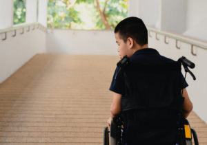 A person with erbs palsy in a wheelchair looking back