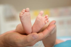 parent holding baby feet