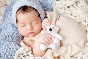 sleeping baby with stuffed animal