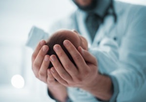 pediatrician holding baby's head