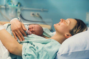 woman holds newborn baby