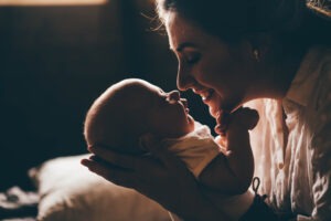 A young mother holds her baby. A Philadelphia umbilical cord birth injury lawyer can help investigate the circumstances of your child's injury.