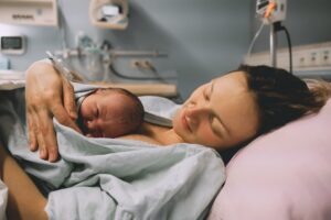 A mother holding her baby, wondering what shoulder dystocia is.