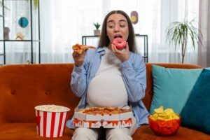 Pregnant woman eating junk food. What can't you eat while pregnant?