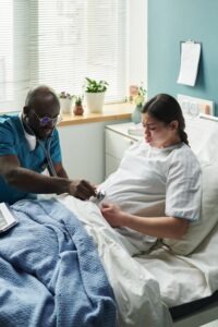A doctor is examining a pregnant woman in a clinical setting, the woman is experiencing pain and wondering what is precipitous labor.