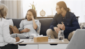 A pregnant woman and her husband are talking to a medical expert about what causes gestational diabetes.